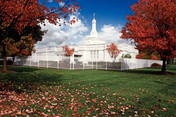The Columbus Ohio temple surrounded by autumn trees and green grass