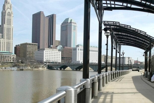 Riverfront walkway and Columbus Ohio skyline in clear sky