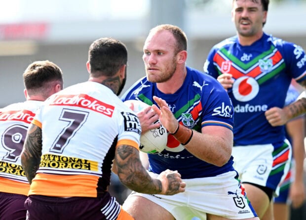 A rugby league player holds the ball while preparing to evade defenders during a match, HD Desktop Wallpaper