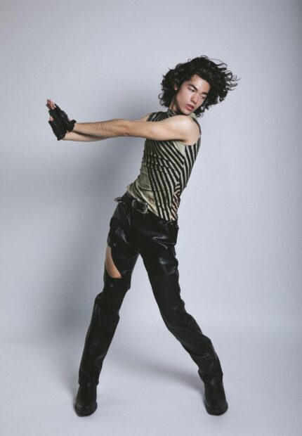 A young man in unique fashion gestures with outstretched arms in this Conan Gray Wallpapers photo, 2K Mobile Wallpaper