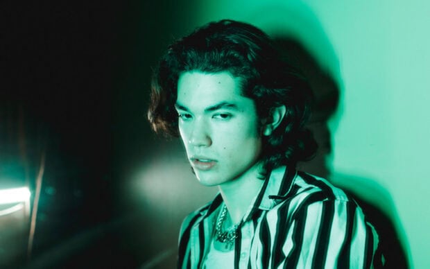 Conan Gray is photographed with moody green lighting and a striped shirt, HD Desktop Wallpaper