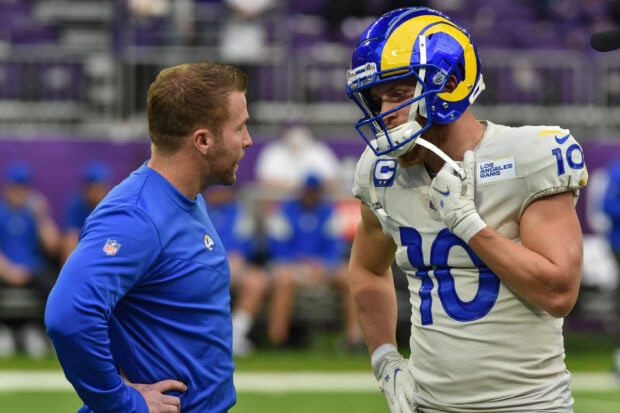 Cooper Kupp discussing strategy with his coach during a football game