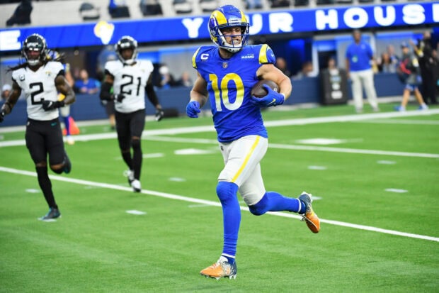 Cooper Kupp running with the football during a game in his blue and yellow uniform