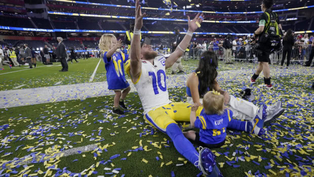 Cooper Kupp celebrating with his children on the field after winning the championship