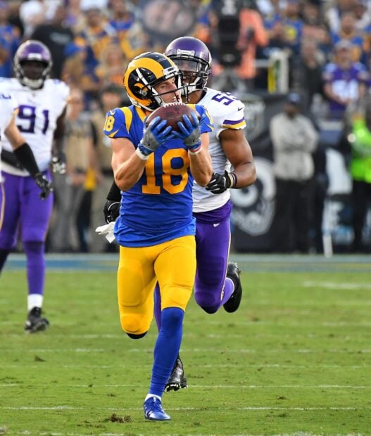 Cooper Kupp catching a football during an NFL game against the Minnesota Vikings