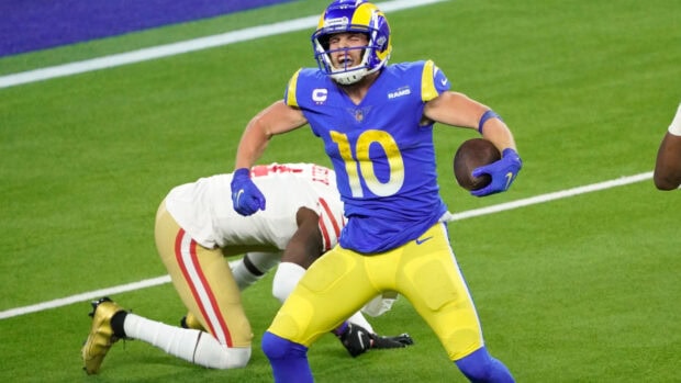 Cooper Kupp celebrates a touchdown in a blue and yellow uniform on a football field