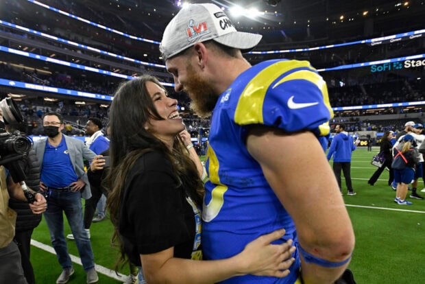 Cooper Kupp celebrating with a woman on the football field after a game
