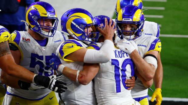 Cooper Kupp celebrating with his teammates during a football game in the Rams uniform