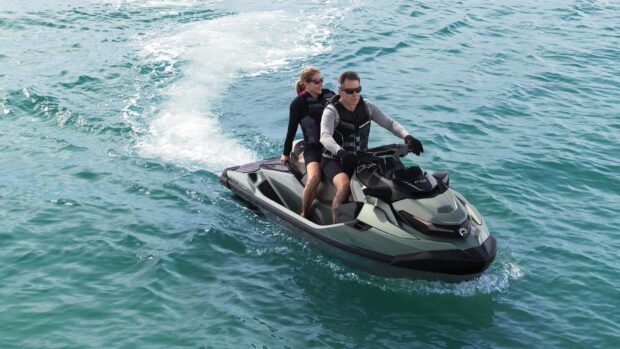 A man and woman enjoy a ride on a jet ski across the clear blue water, HD Desktop Wallpaper