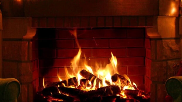 A cozy burning fire with glowing logs in a brick fireplace, HD Desktop Wallpaper