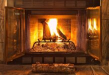 A burning fireplace with glowing logs surrounded by a brick interior, HD Desktop Wallpaper