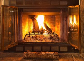A burning fireplace with glowing logs surrounded by a brick interior, HD Desktop Wallpaper