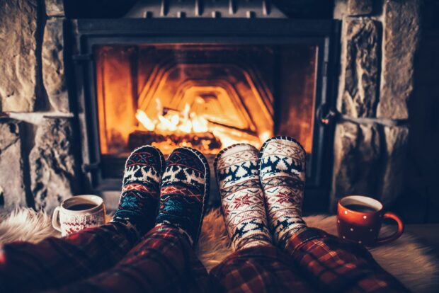 Two people in warm socks sitting by the fireplace with hot drinks, HD Desktop Wallpaper