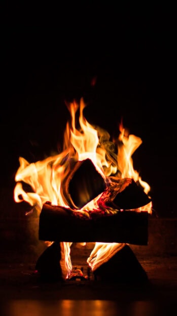 A close up of a cozy glowing fireplace fire burning logs brightly, HD Phone Wallpaper