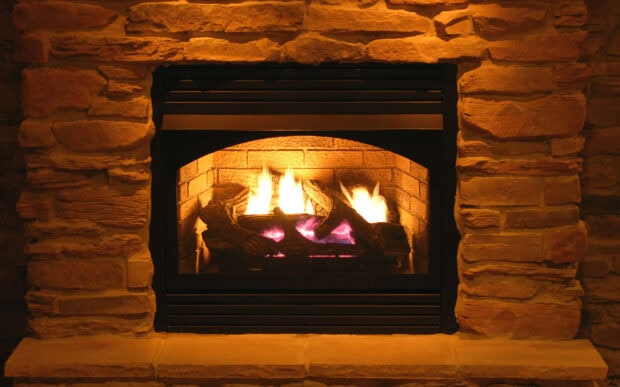 A warm stone fireplace with a glowing fire burning inside the hearth, HD Desktop Wallpaper