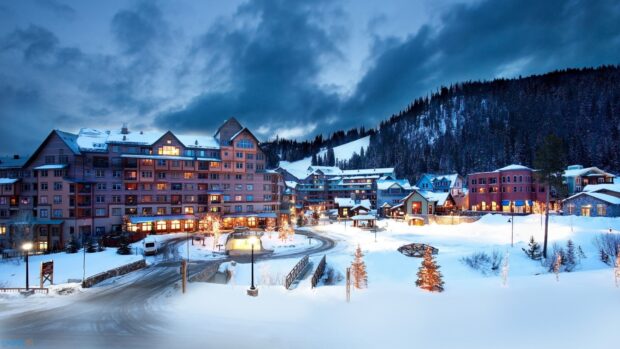 A snowy village in Austria with warmly lit buildings during evening, HD Desktop Wallpaper