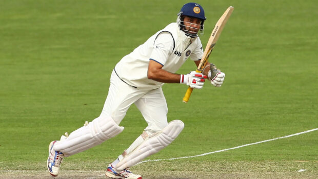 Indian cricket player wearing helmet batting on the cricket field in action