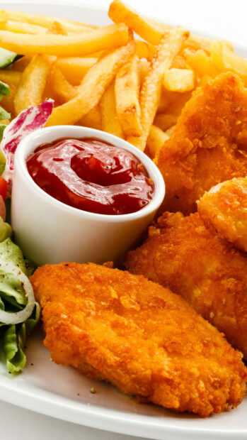 A plate of crispy fried chicken nuggets and french fries served with ketchup and salad, 2K Phone Wallpaper