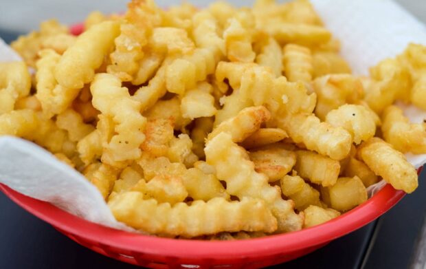 A basket filled with crispy golden French fries ready to eat, HD Desktop Wallpaper