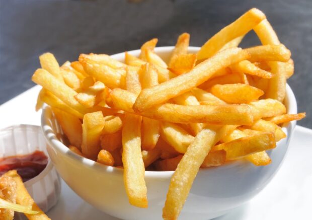 A bowl of crispy golden french fries served with ketchup on the side, HD Desktop Wallpaper