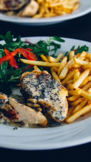 A plate of French fries served with chicken in creamy sauce and fresh vegetables, HD Mobile Wallpaper