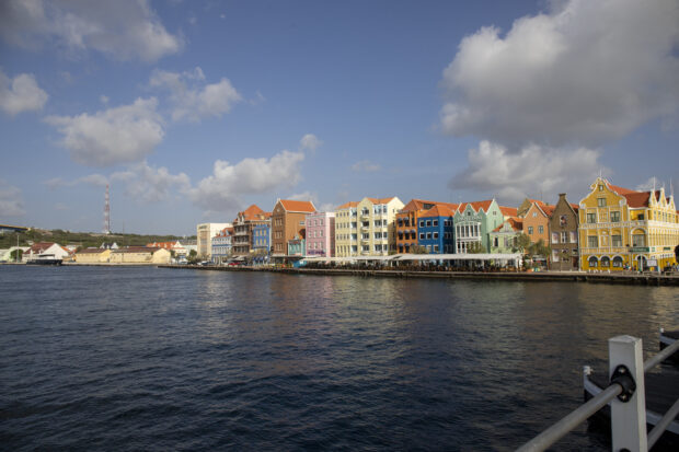 Colorful buildings along the waterfront in Curacao Island under a blue sky