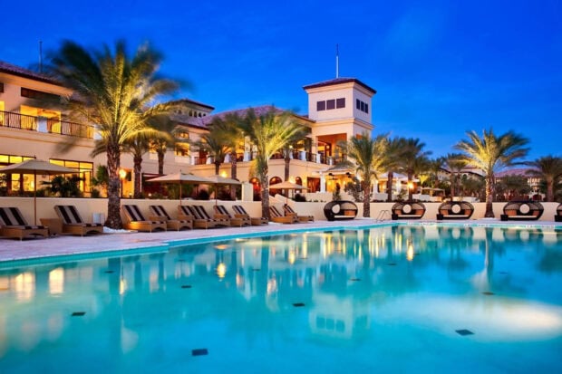 Luxury resort with palm trees near Curacao Island at twilight