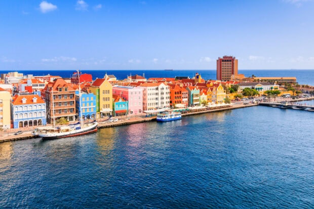 A vibrant cityscape of Curacao island featuring colorful buildings along the waterfront