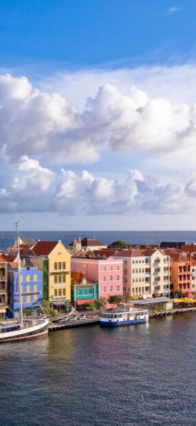 Colorful buildings along Curacao Island waterfront with clear sky