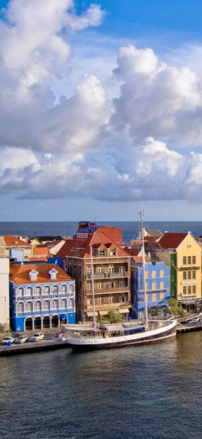 Colorful buildings with red roofs near the waterfront on Curacao Island
