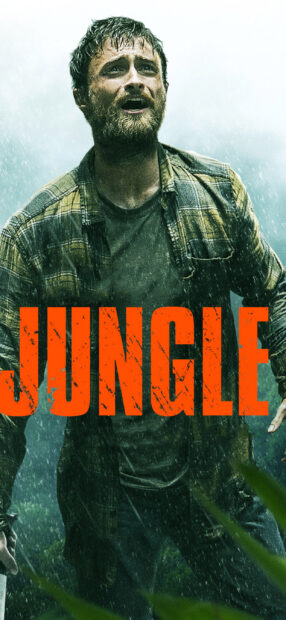 Daniel Radcliffe is standing in heavy rain wearing a plaid shirt in a jungle setting, 2K Mobile Wallpaper