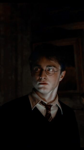 Daniel Radcliffe Wallpapers showing a serious expression in a dimly lit setting, HD Phone Wallpaper