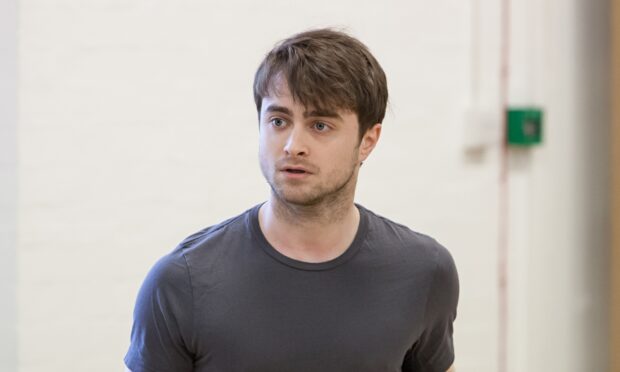 Daniel Radcliffe appears serious while wearing a dark shirt indoors, 2K Desktop Wallpaper