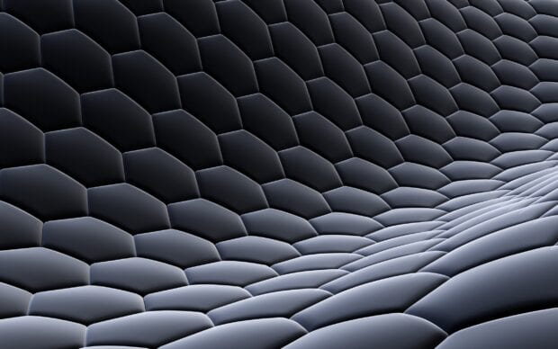 A detailed view of a dark honeycomb pattern showcasing smooth hexagonal shapes, 2K Desktop Wallpaper