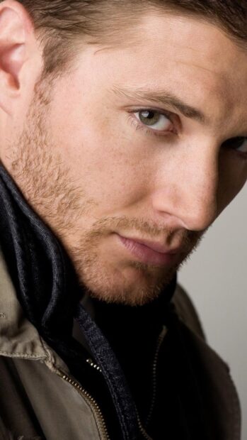 Close up of Dean Winchester with intense green eyes and beard showing texture