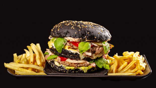 A close up of French fries with a black sesame burger and fresh greens on a plate, 2K Desktop Wallpaper