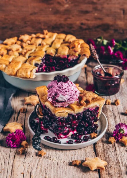 A slice of berry pie topped with purple ice cream and fresh berries on a wooden table, HD Phone Wallpaper