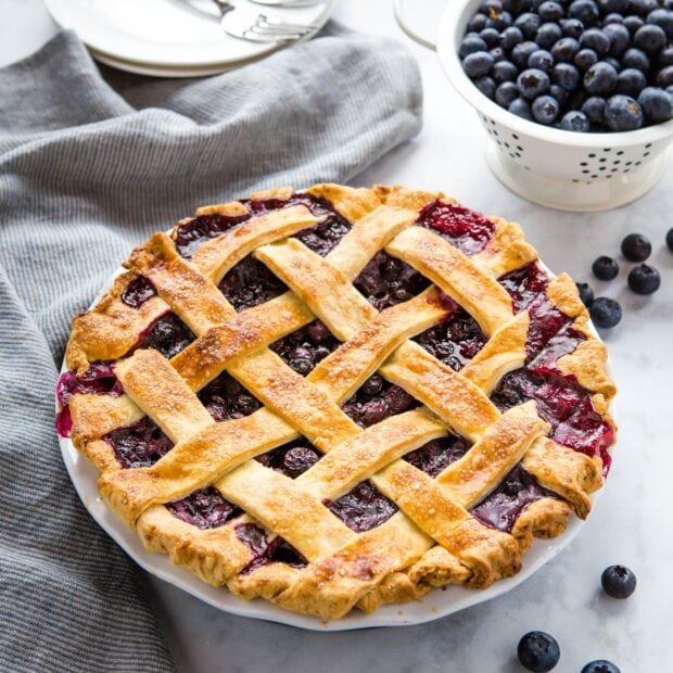 A freshly baked blueberry pie with a golden lattice crust on a plate, HD Desktop Wallpaper