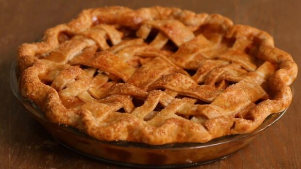 A freshly baked apple pie with a golden lattice crust on a wooden table, HD Desktop Wallpaper