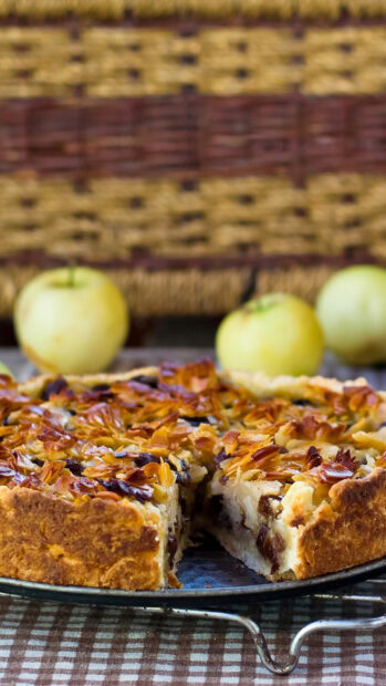 A close up of a delicious pie with nut topping and a slice removed on a rustic table, HD Phone Wallpaper