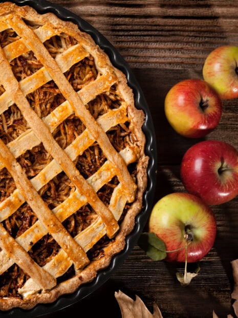 A delicious rustic apple pie with fresh apples on wooden table, 2K Desktop Wallpaper
