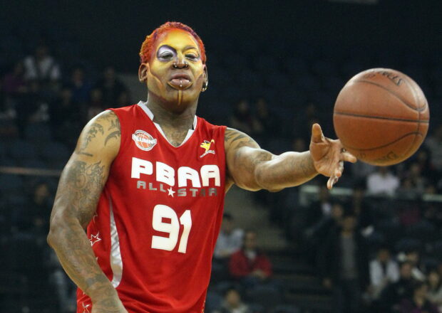 Dennis Rodman playing basketball in a red jersey during a game