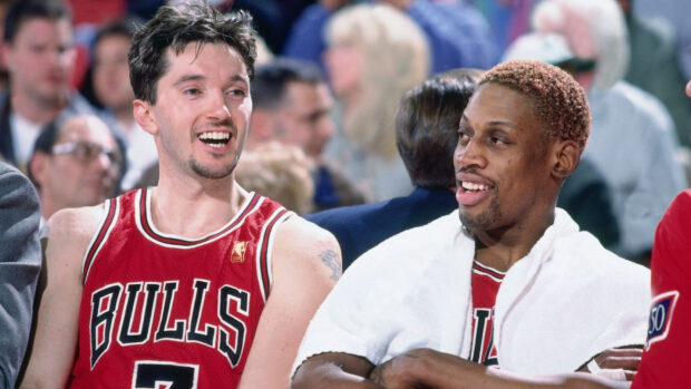 Chicago Bulls players Dennis Rodman and John Paxson smiling on the bench during a game