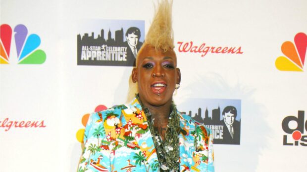 Dennis Rodman wearing a colorful tropical suit and distinctive hairstyle at a celebrity event