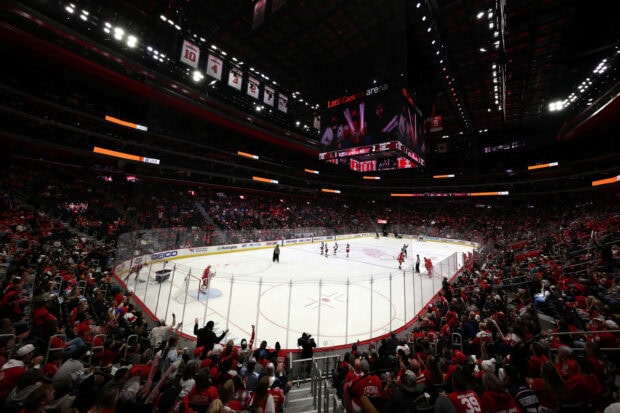 A wide view of a Detroit Red Wings hockey game in progress at an arena filled with fans