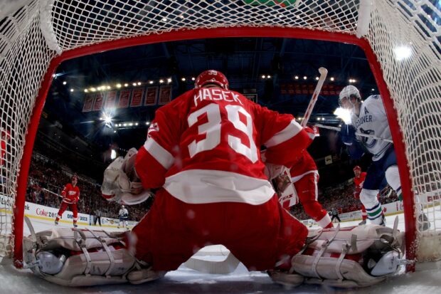 Detroit Red Wings player Hasek defending the goal during a hockey game
