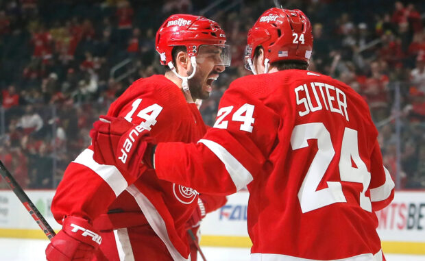 Detroit Red Wings players celebrating during an intense ice hockey game