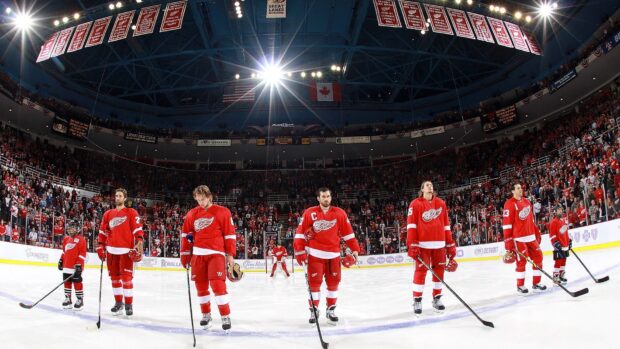 Detroit Red Wings players lined up on ice rink before game in stadium