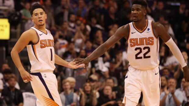 Devin Booker shares a high five during a basketball game, HD Desktop Wallpaper