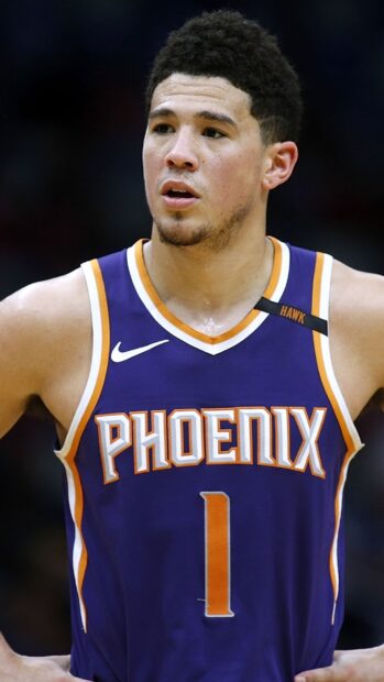 Devin Booker is wearing a Phoenix basketball jersey during a game, 2K Phone Wallpaper